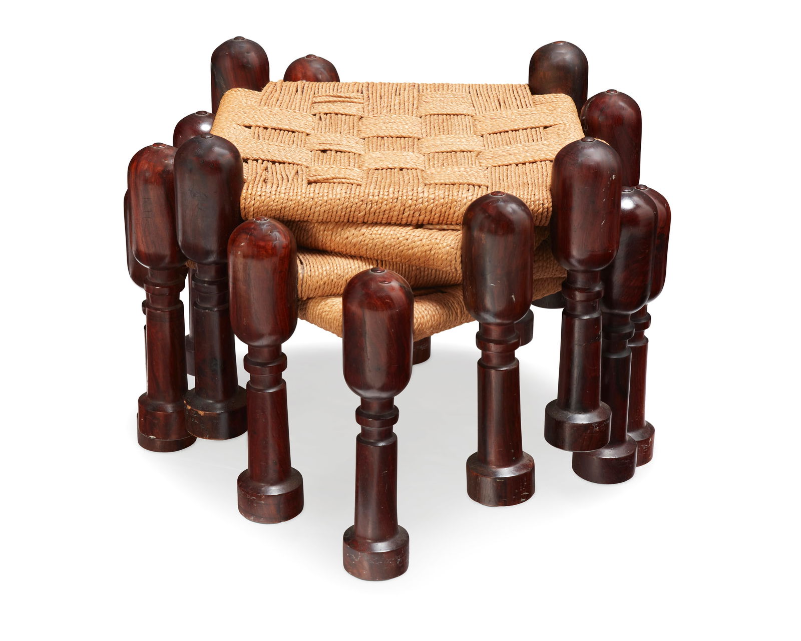 A set of four M. Hayat Brothers rosewood stacking stools: Y A set of four M. Hayat Brothers rosewood stacking stoolsMid-20th century; Peshawar, PakistanEach with wood frame and woven cord seat4 piecesEach: 13.25" H x 18" W x 18" D This lot may require a CITE