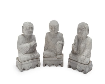 Three Asian molded cast stone monk figures