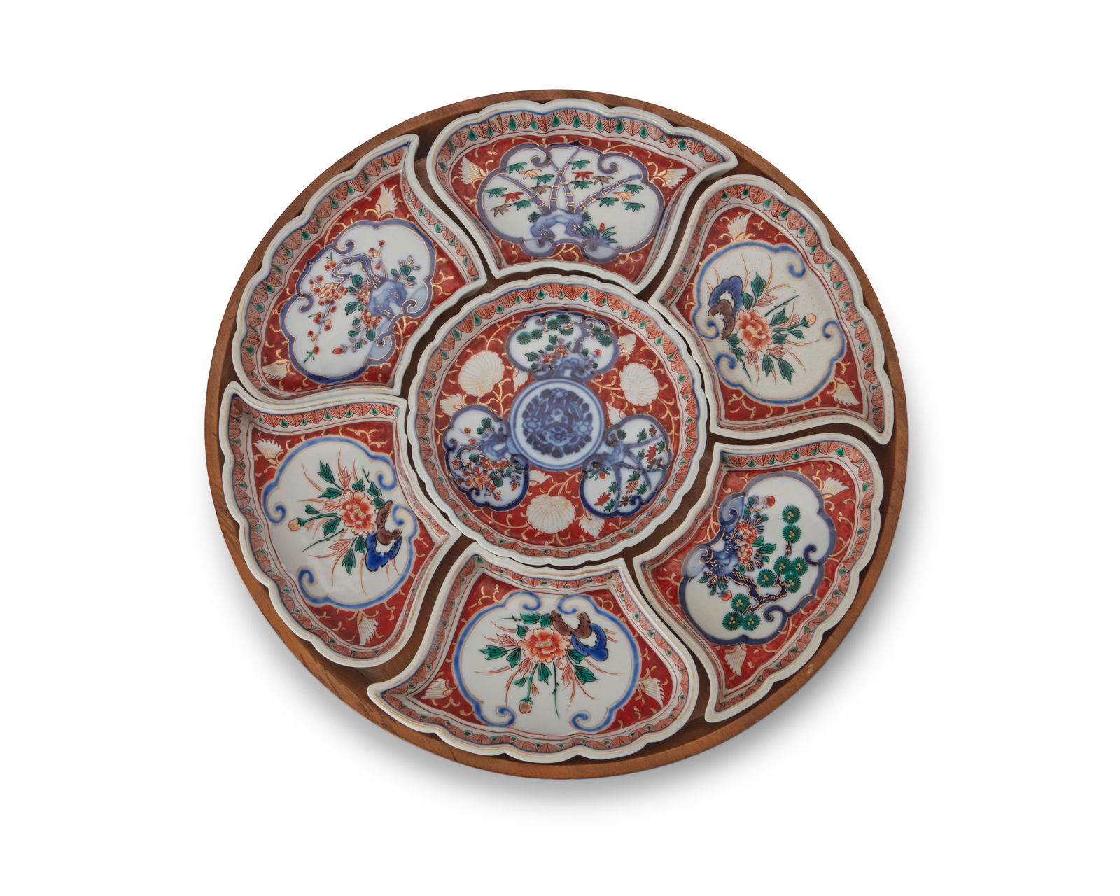 A Japanese porcelain sweet-meat set: A Japanese porcelain sweet-meat set20th centuryEach piece and tray marked: JapanThe seven-piece set of enameled ceramic dishes, each depicting foliate scenes, set in a wood boxOverall: 1.25" H x 13.5"