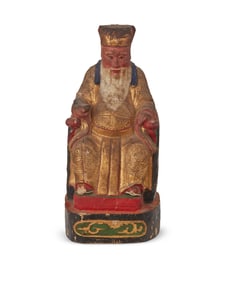 An Asian polychrome carved wood deity figure