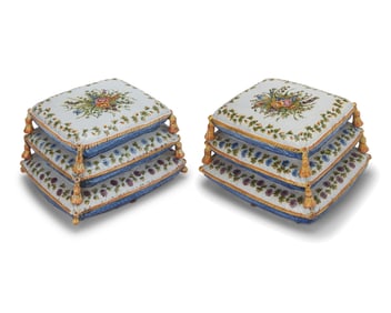 A pair of Continental glazed earthenware stacked cushion footstools