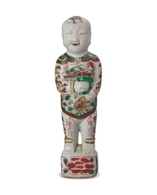 A Chinese polychrome porcelain figure of a boy