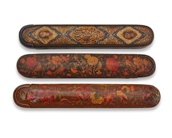 Three Persian polychrome wood and papier-m‚che pen boxes