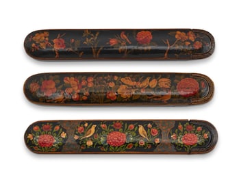 Three Persian polychrome wood and papier-m‚che pen boxes