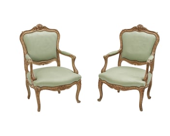 A pair of Italian Rococo giltwood open armchairs