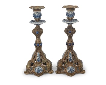 A pair of Baroque-style porcelain-mounted brass candlesticks