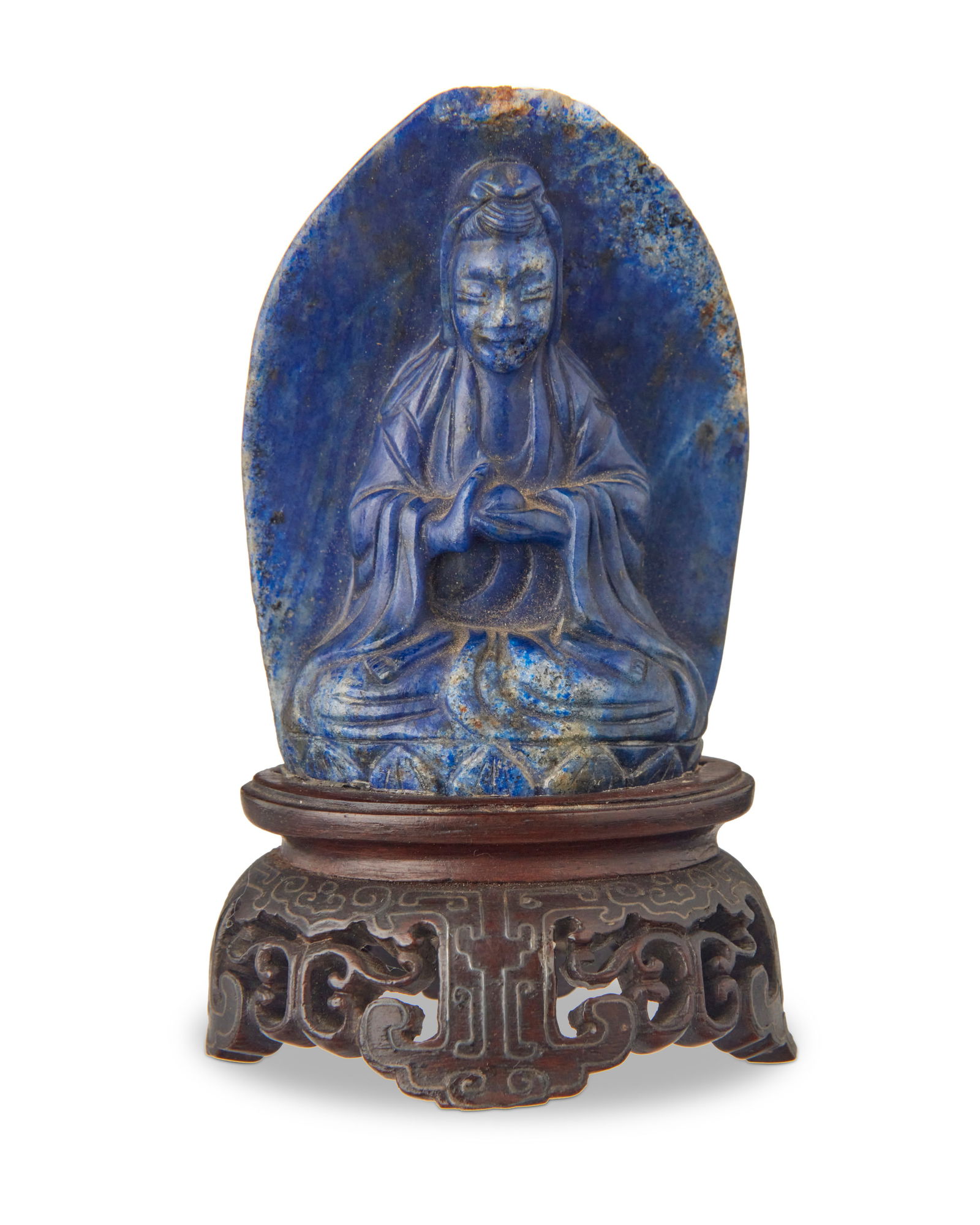 A diminutive Chinese carved lapis figure of Guanyin: A diminutive Chinese carved lapis figure of GuanyinLate Qing Dynasty (1644-1912) or laterSet on a carved and metal-inlaid hardwood standStone: 2.25" H x 1.625" W x 1" D; Stand: 1" H x 1.875" W x 1.5"