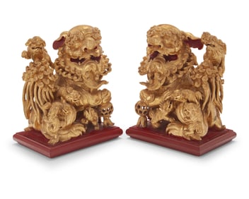 A pair of Chinese carved giltwood guardian lions