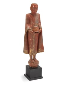 A Southeast Asian lacquered carved wood donor figure