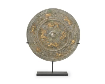 A Chinese silvered and gilt-bronze mirror