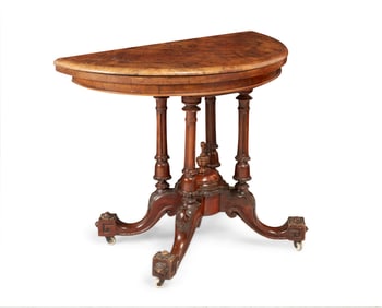 A Victorian carved wood fold-over games table