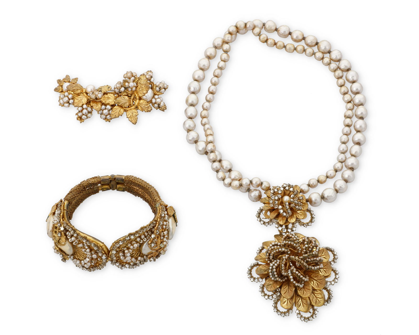 Miriam Haskell: A Group of Vintage Costume Jewelry: Miriam Haskell: A Group of Vintage Costume JewelryThree works in gold-toned metal with faux pearls and rhinestones comprising a front-clasp choker necklace with a large floral pendant suspended from t