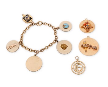 A Gold and Mixed Metal Charm Bracelet and Charms