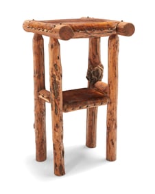 A natural wood and hide pedestal table