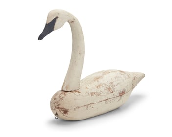 A carved wood swan decoy