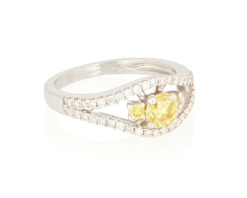 An 18K White Gold, Fancy Vivid Yellow Diamond and Diamond Ring