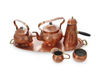 A hammered copper coffee, tea, and hot chocolate service
