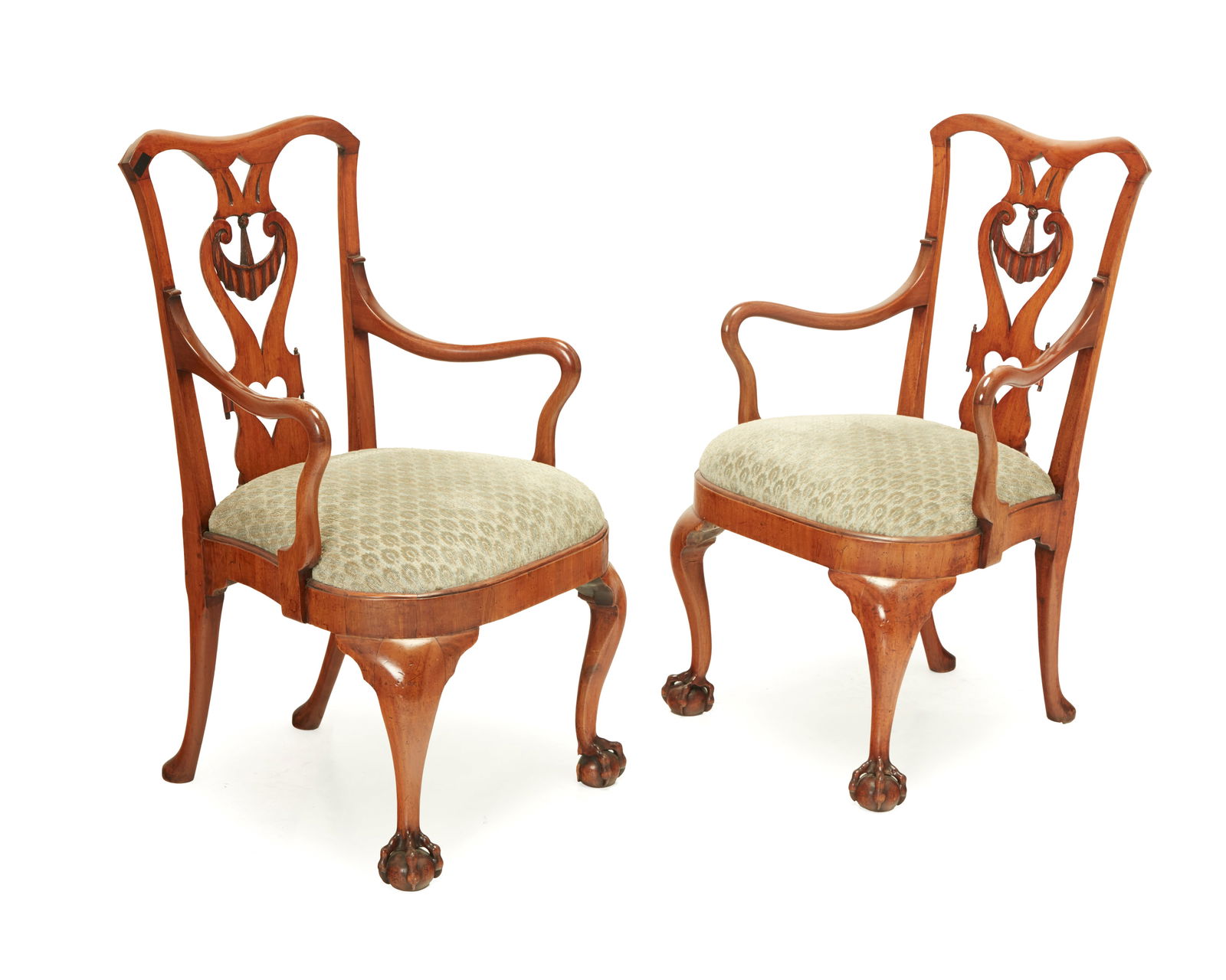 A pair of George II-style upholstered chairs: A pair of George II-style upholstered chairs19th century with later elementsEach back with carved openwork splat depicting a fabric swag and heart, raised on ball in claw feet, later upholstered in a