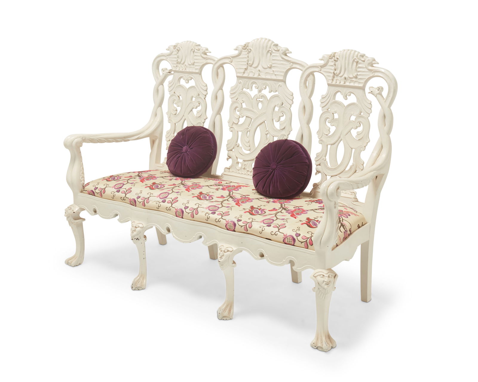 A Dutch Rococo-style white painted settee: A Dutch Rococo-style white painted settee20th centuryThe carved wood frame with openwork seatback featuring bird-form figural and scrolled motifs, above a later fabric upholstered seat cushion, set on