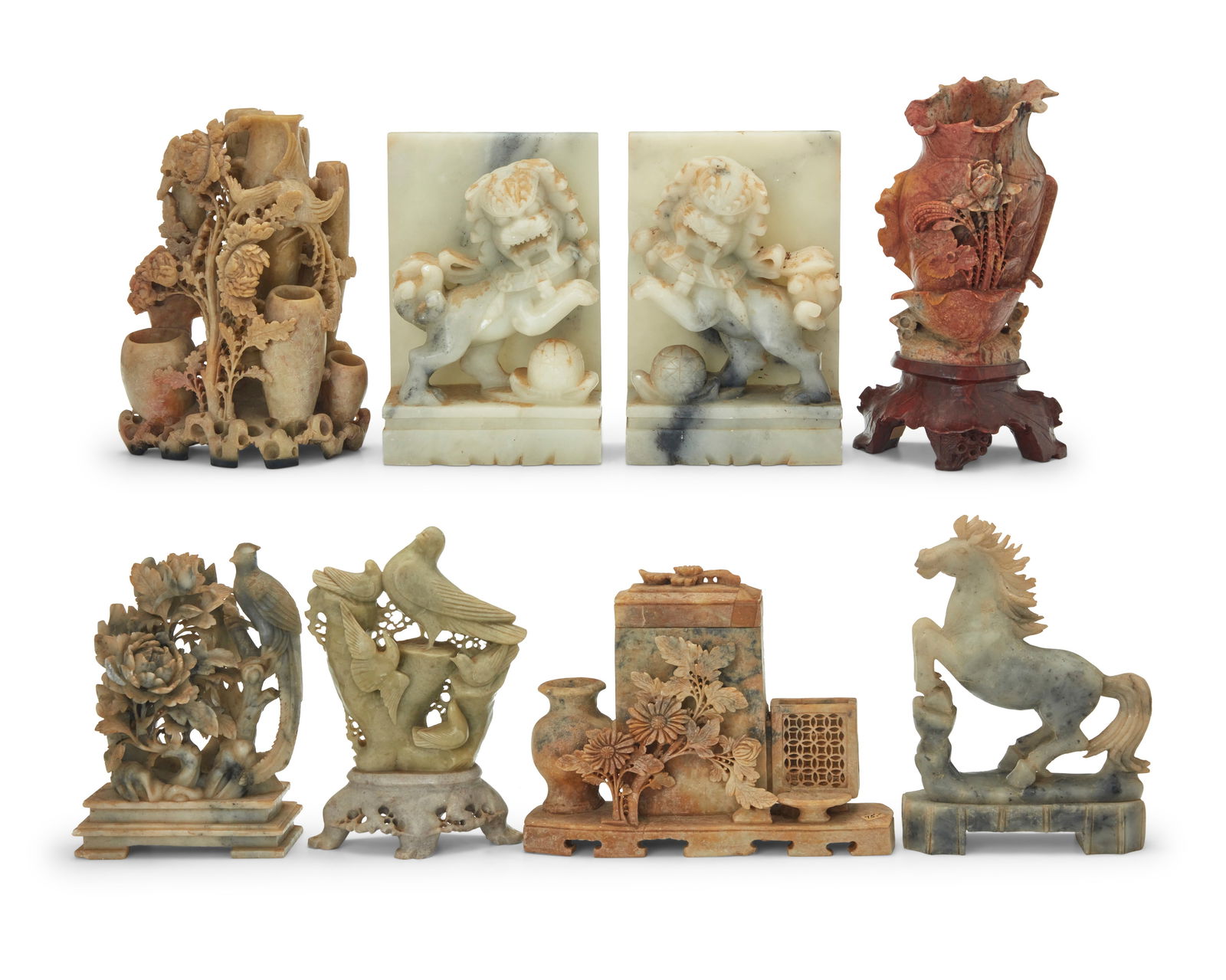 A group of Chinese carved hardstone carvings: A group of Chinese carved hardstone carvings20th centuryComprising a pair of guardian lion bookends, two floriform vases, a bird figural group, a horse, a phoenix and peony group, and a group of homew