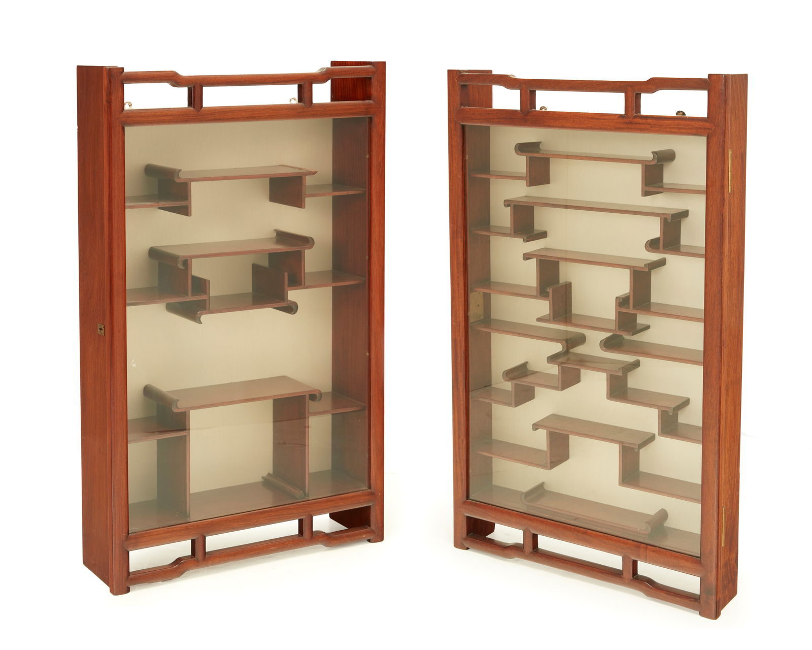 Two chinoiserie hardwood wall-mounted display cabinets: Two chinoiserie hardwood wall-mounted display cabinetsMid-20th centuryEach with locking glazed door revealing a fitted shelf interior with fabric backing2 piecesLarger: 33.5" H x 20" W x 6" D; Smaller