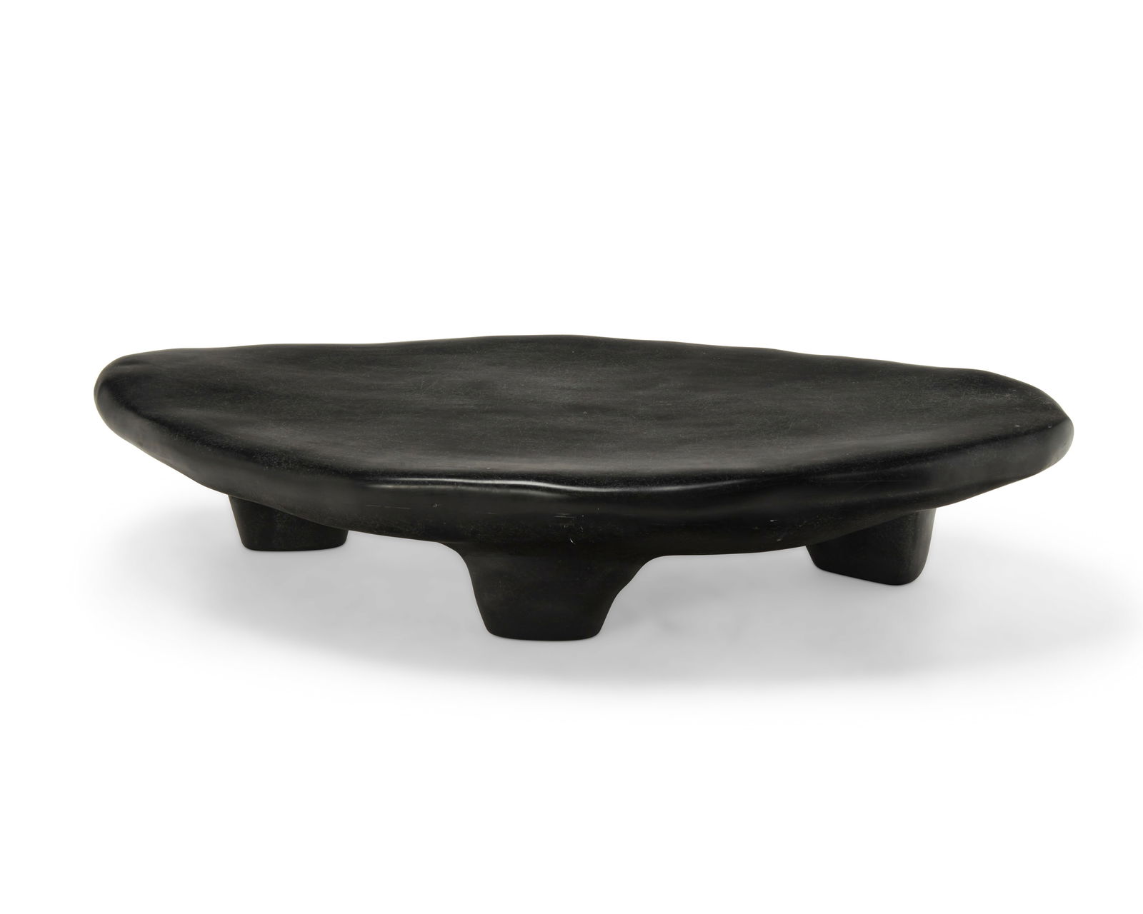 A Kar-studio fiberglass 'Tripod Coffee Table': A Kar-studio fiberglass 'Tripod Coffee Table'Early 21st centuryImpressed to base of one leg: Kar-The molded fiberglass biomorphic table in black, raised on three legs11.75" H x 59.5" W x 31.5" D