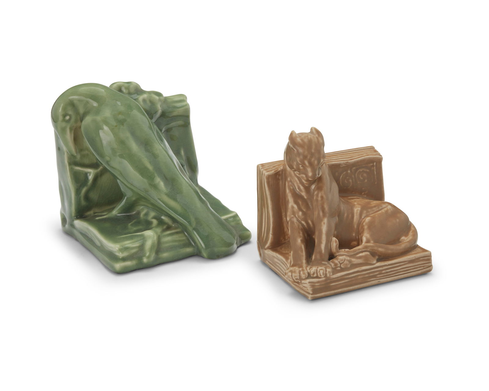 Two Rookwood pottery bookends: Two Rookwood pottery bookends1927 and 1947Each marked for Rookwood; panther dated and numbered: 2564; also with artist's cipher: Mc [William P. McDonald (1863-1931)]; raven dated and numbered: 2274Com