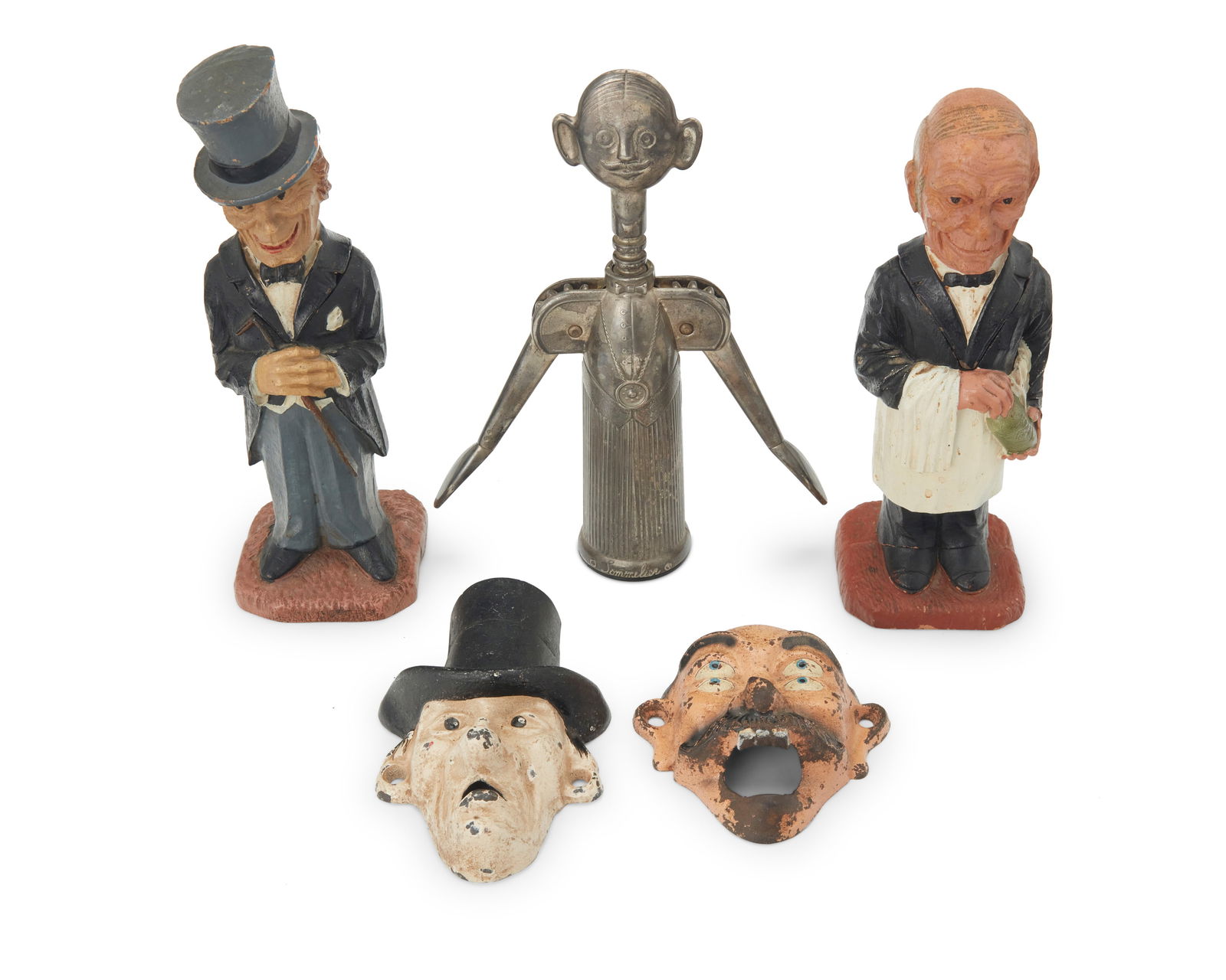 A group of figural bottle openers: A group of figural bottle openersLate 19th/20th centuryComprising two painted carved wood figures of a butler and a dandy, each housing a corkscrew, one metal sommelier figural wine opener, and two en