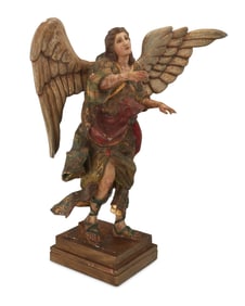 A Continental polychrome carved wood figure of an archangel