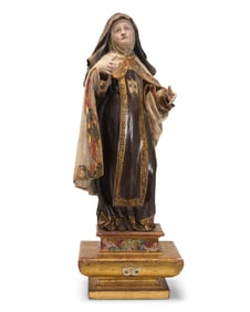 A Spanish Colonial polychrome carved wood figure of St. Theresa of Avila