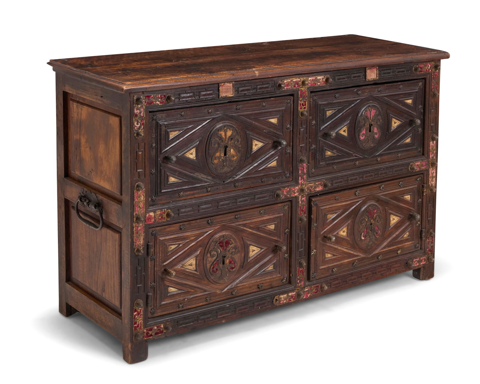 A Spanish Colonial lower vargueno chest: A Spanish Colonial lower vargueno chest18th century or laterComprising two drawers above two hinged cabinet doors, each front decorated with carved geometric motifs accented by inset bone and wrought-