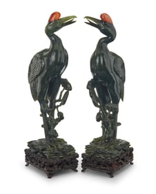 A pair of Chinese carved nephrite and carnelian figures of cranes