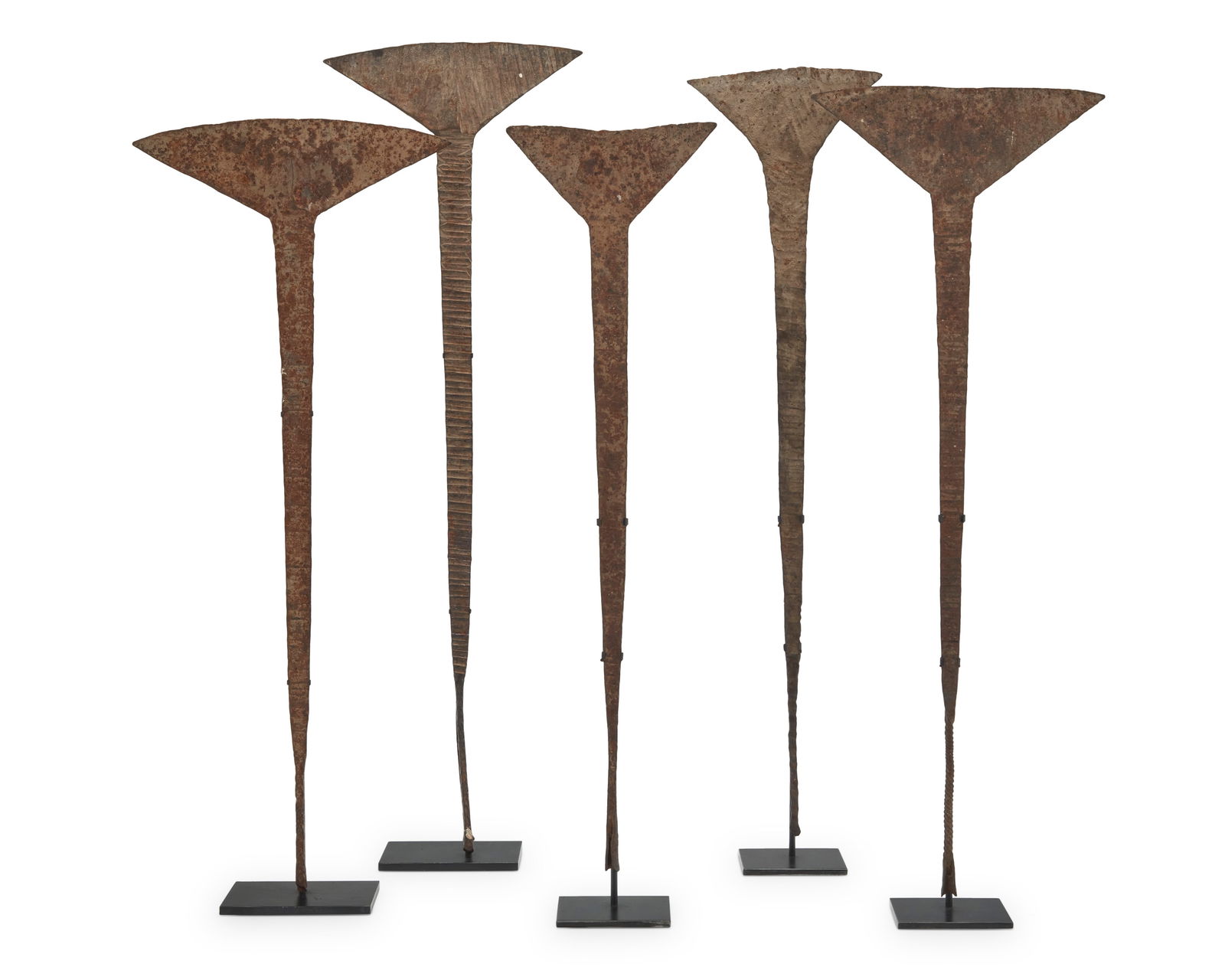 A group of African Idoma 'akika' iron currency: A group of African Idoma 'akika' iron currencyLate 19th/20th century; NigeriaEach hammered iron, mounted to an enameled metal stand5 piecesTallest: 31.25" H x 10" W; Shortest: 26.25" H x 7.5" W Proven