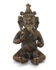 An Indian brass figure of infant Ganesha