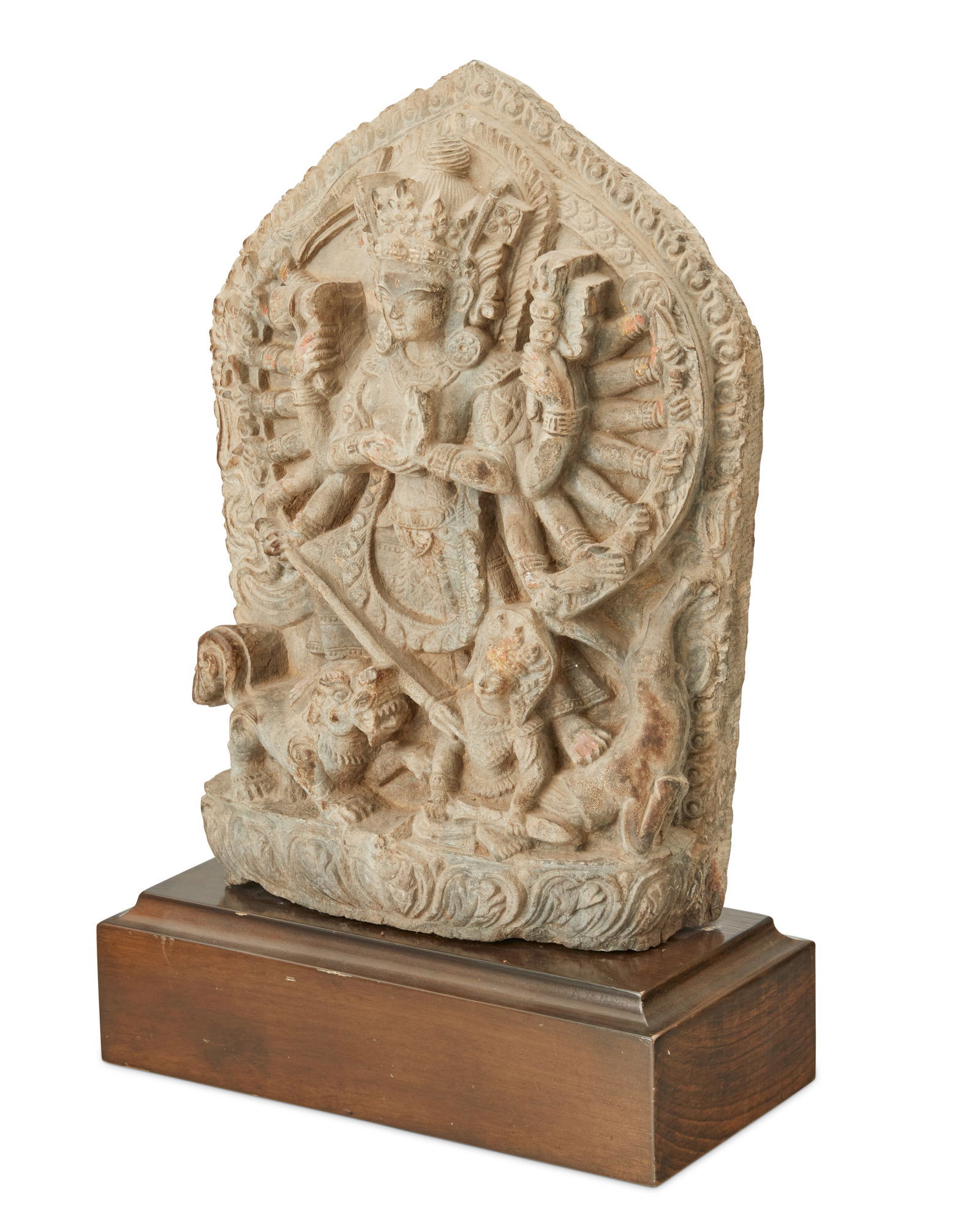 A Nepalese stele of Durga slaying the demon Mahishasura: A Nepalese stele of Durga slaying the demon Mahishasura 17th century Durga standing with one foot on her tiger and the other on the buffalo body of Mahishasura, holding various weapons, with her