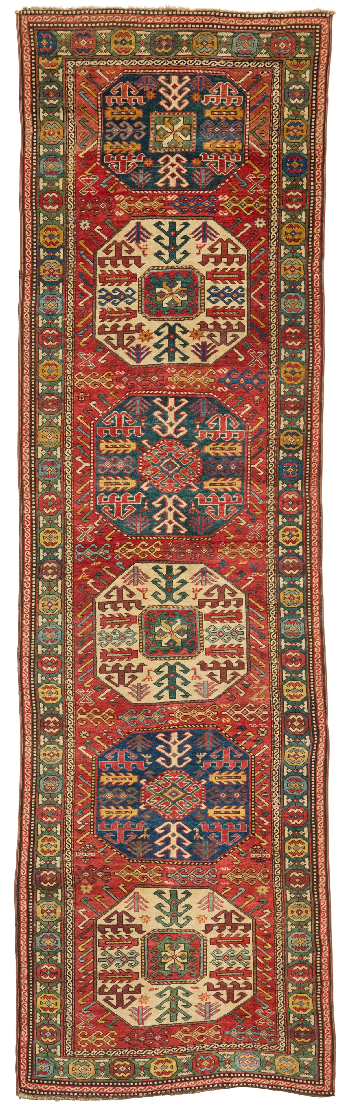 A Kazak runner: A Kazak runner Early 20th century Wool on wool foundation 12' 1" L x 3' 7" W