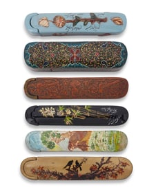 A group of Persian polychrome wood and papier-m‚che pen boxes
