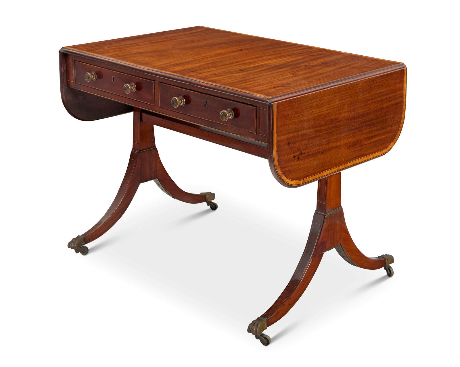 A Regency mahogany sofa table: A Regency mahogany sofa tableEarly 19th centuryOne side with two locking drawers, the other with false fronts, flanked by swingarm drop leaves, raised on brass paw feet and casters27.25" H x 35.5" W x