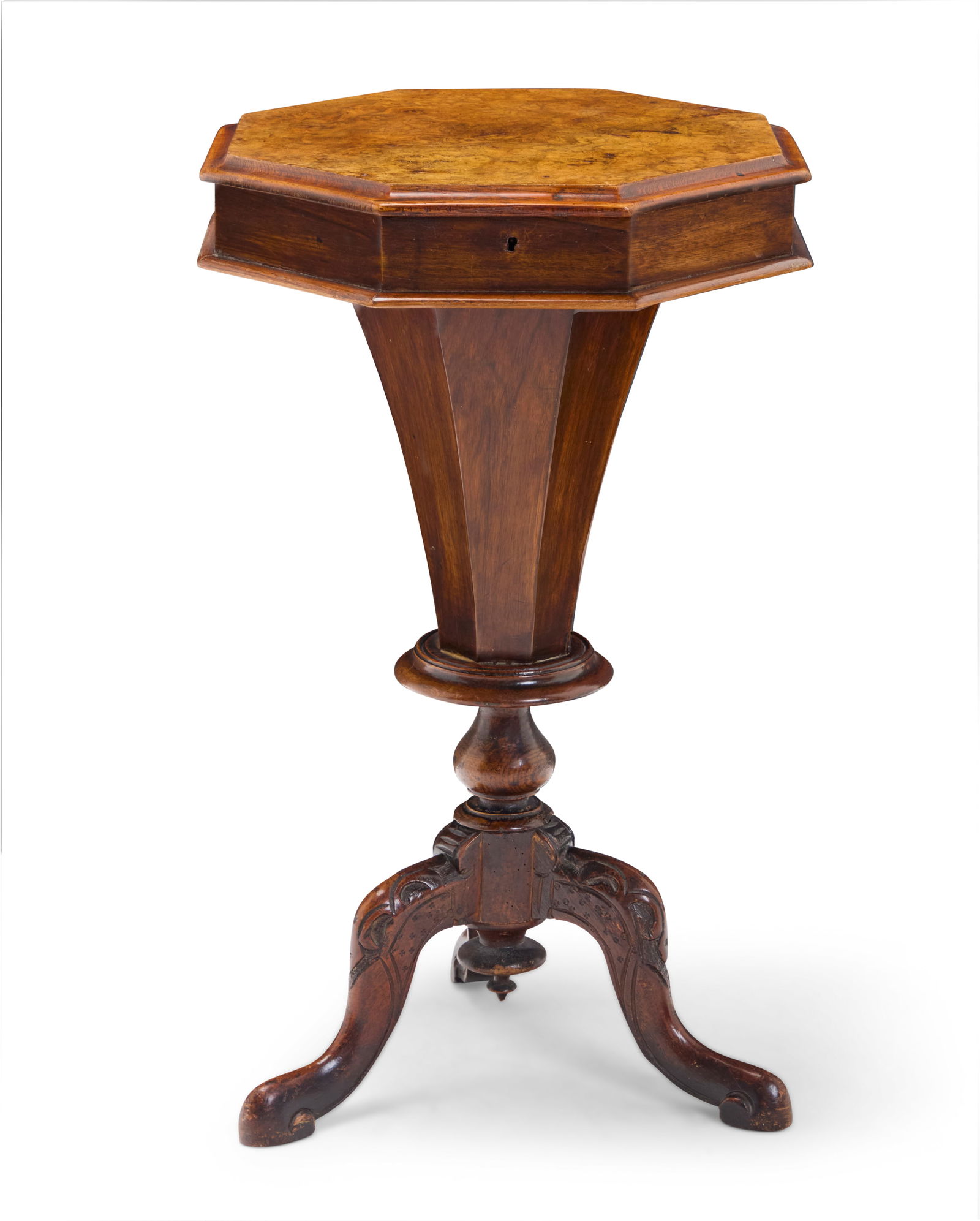A Regency burl walnut work table: A Regency burl walnut work table Early 19th century The locking hinged top opening to reveal a fitted interior later lined in paper, raised on a carved tripod base with scrolled feet 27.5" H x 16" W