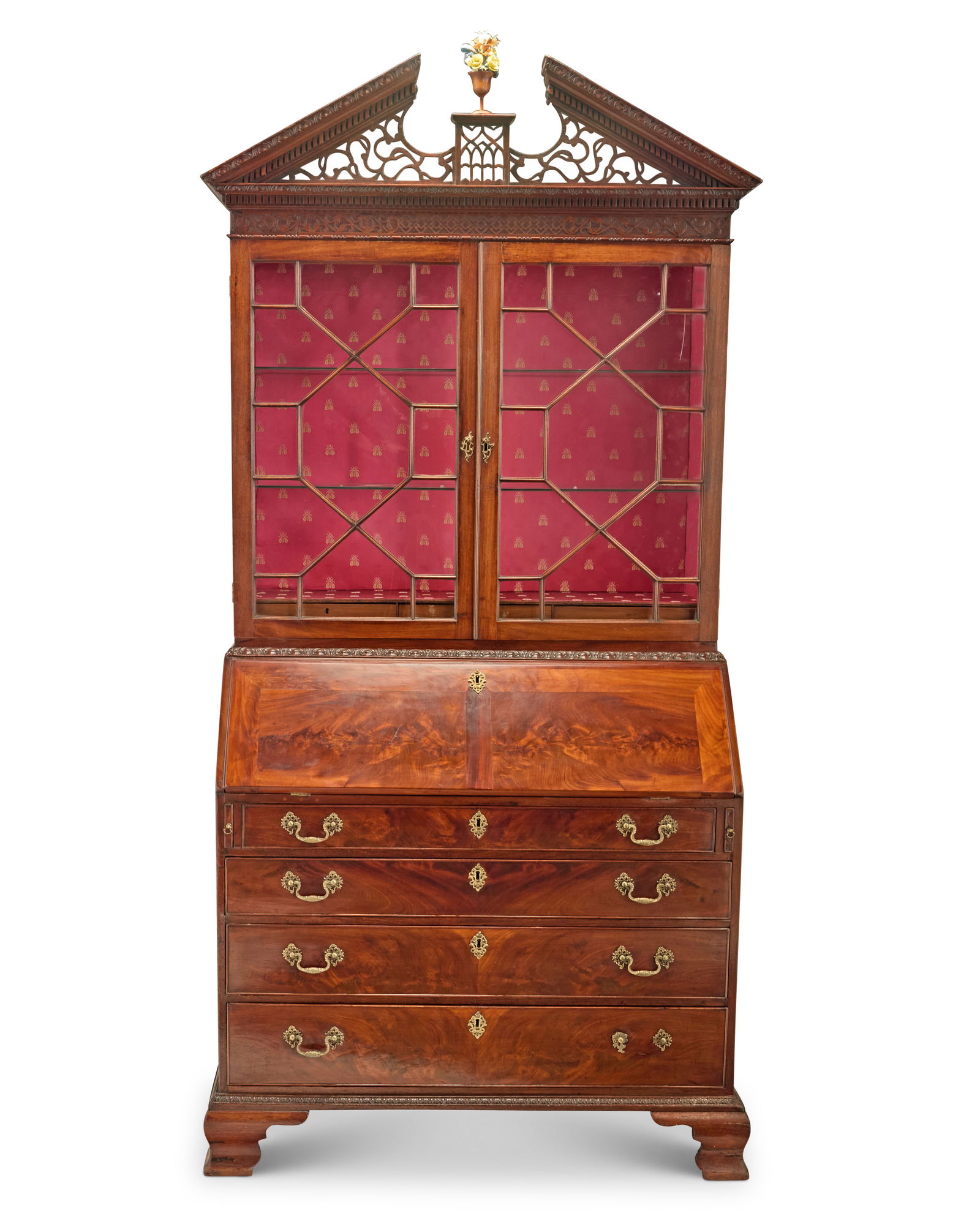 A George III mahogany secretary bookcase: A George III mahogany secretary bookcaseLate 18th/early 19th centuryThe upper console with openwork broken pediment with denticulated trim above an astragal glazed cabinet with later upholstered and i