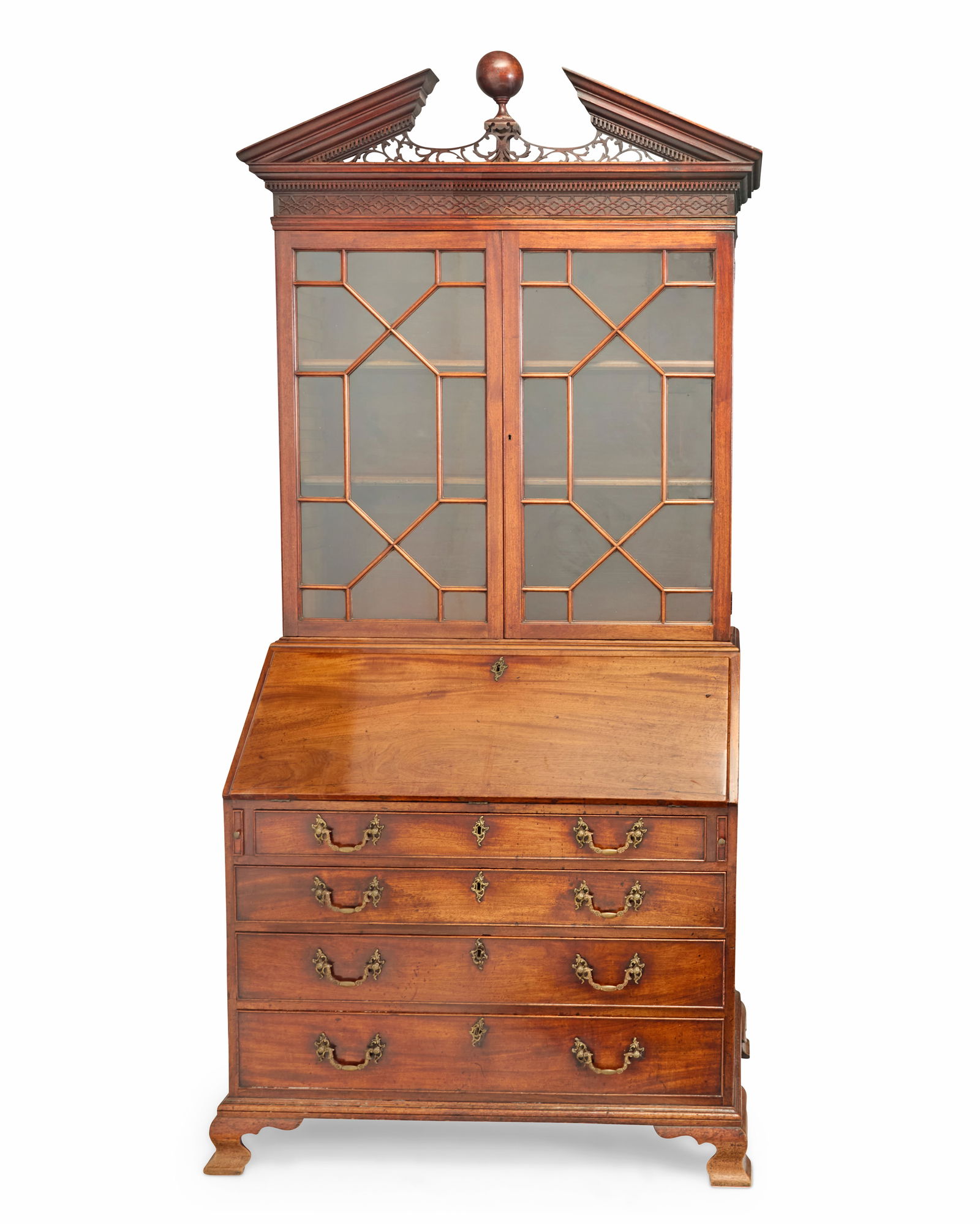 A George III mahogany secretary cabinet: A George III mahogany secretary cabinet Early 19th century The astragal glazed upper console surmounted by an openwork broken pediment and globe finial, opening to reveal two adjustable shelves,