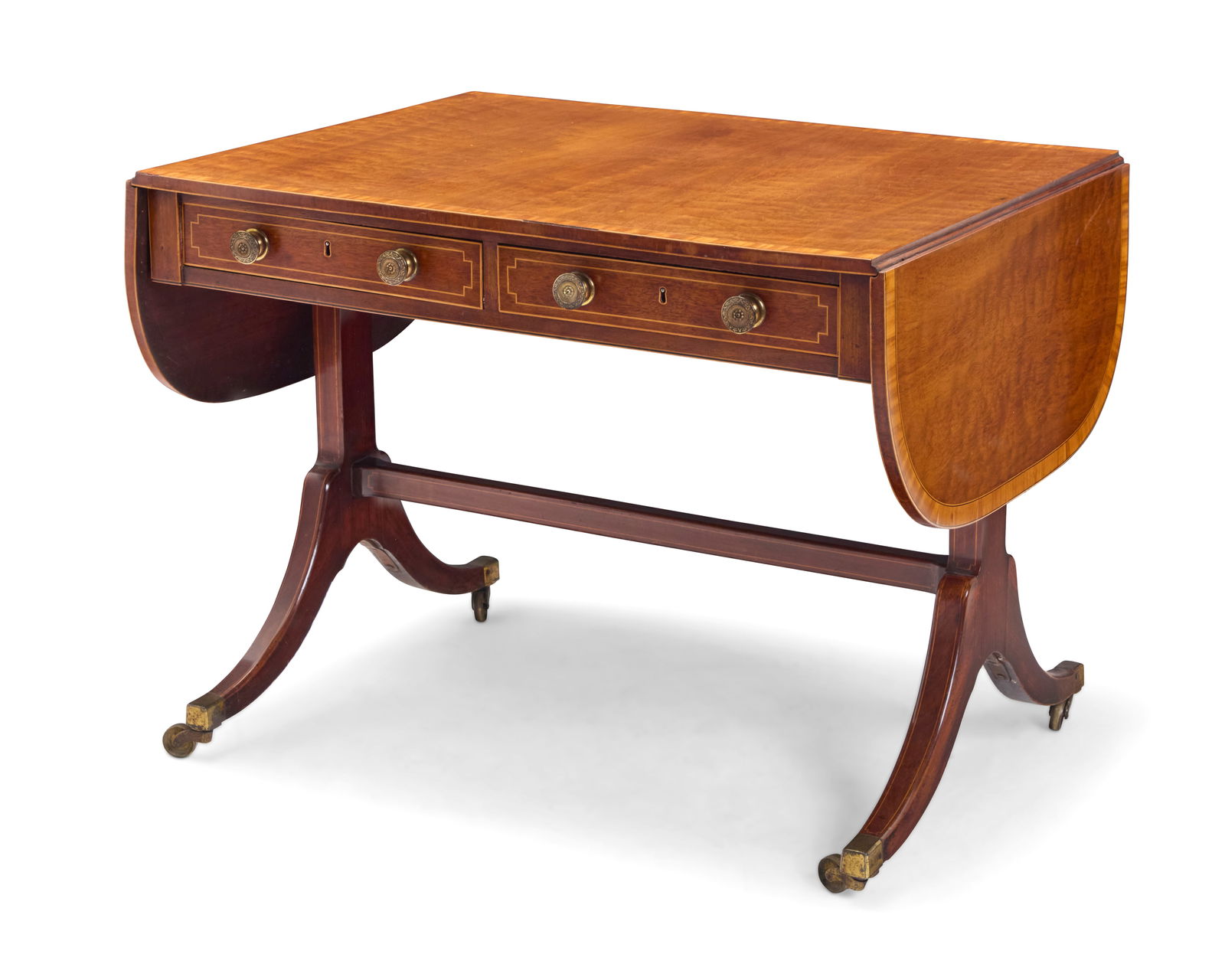 A Regency style inlaid mahogany sofa table: A Regency style inlaid mahogany sofa table20th centuryWith opposed drop leaves flanking two locking drawers to one side and false fronts to the other, raised on brass castersStored: 27.25" H x 36.25"