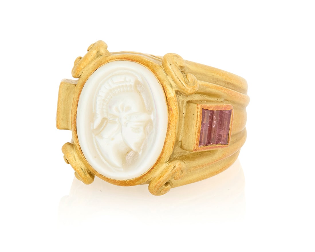 Joan Boyce: An 18K Gold, Mother-of-Pearl and Pink Tourmaline Ring: Joan Boyce: An 18K Gold, Mother-of-Pearl and Pink Tourmaline RingFeaturing carved mother-of-pearl soldier cameo, accented by six baguette pink tourmalines, signed JBLSize: 618.5 grams grossProperty of