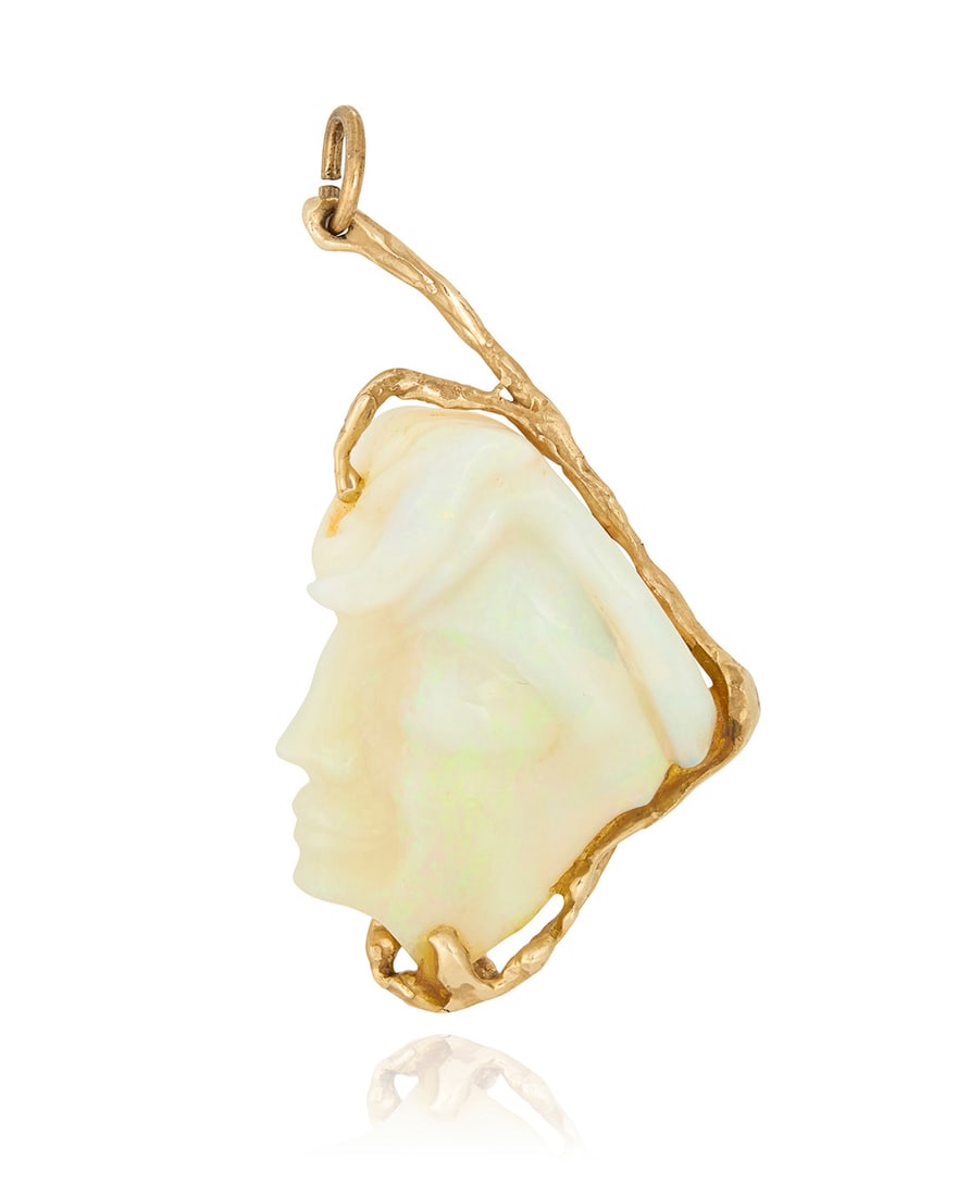 A 14K Gold and Opal Pendant: A 14K Gold and Opal Pendant Of an organic design featuring a carved opal of a woman's profile measuring approximately 40.00 x 30.00 x 6.27 mm Measures: 2 1/2 X 1 1/4 in. 16.0 grams gross 