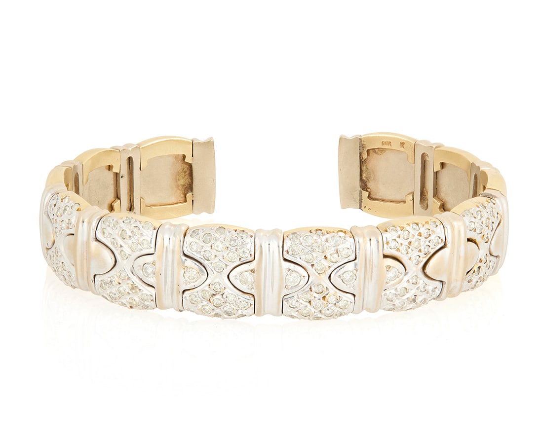 A 14K Gold, Stainless-Steel and Diamond Cuff: A 14K Gold, Stainless-Steel and Diamond Cuff Featuring interlocking segments set with round diamonds weighing approximately 2.75 carats Measures: 6 in., 3/4 in. gap 55.5 grams gross Provenance: