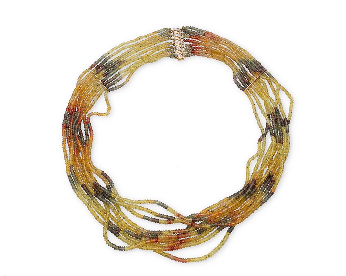 A 14K Bi-Color Gold and Colored Sapphire Bead Necklace: A 14K Bi-Color Gold and Colored Sapphire Bead NecklaceIncluding nine rows of faceted colored sapphires included, blue, green, orange and yellow, finished with a bi-color gold clasp set with five round