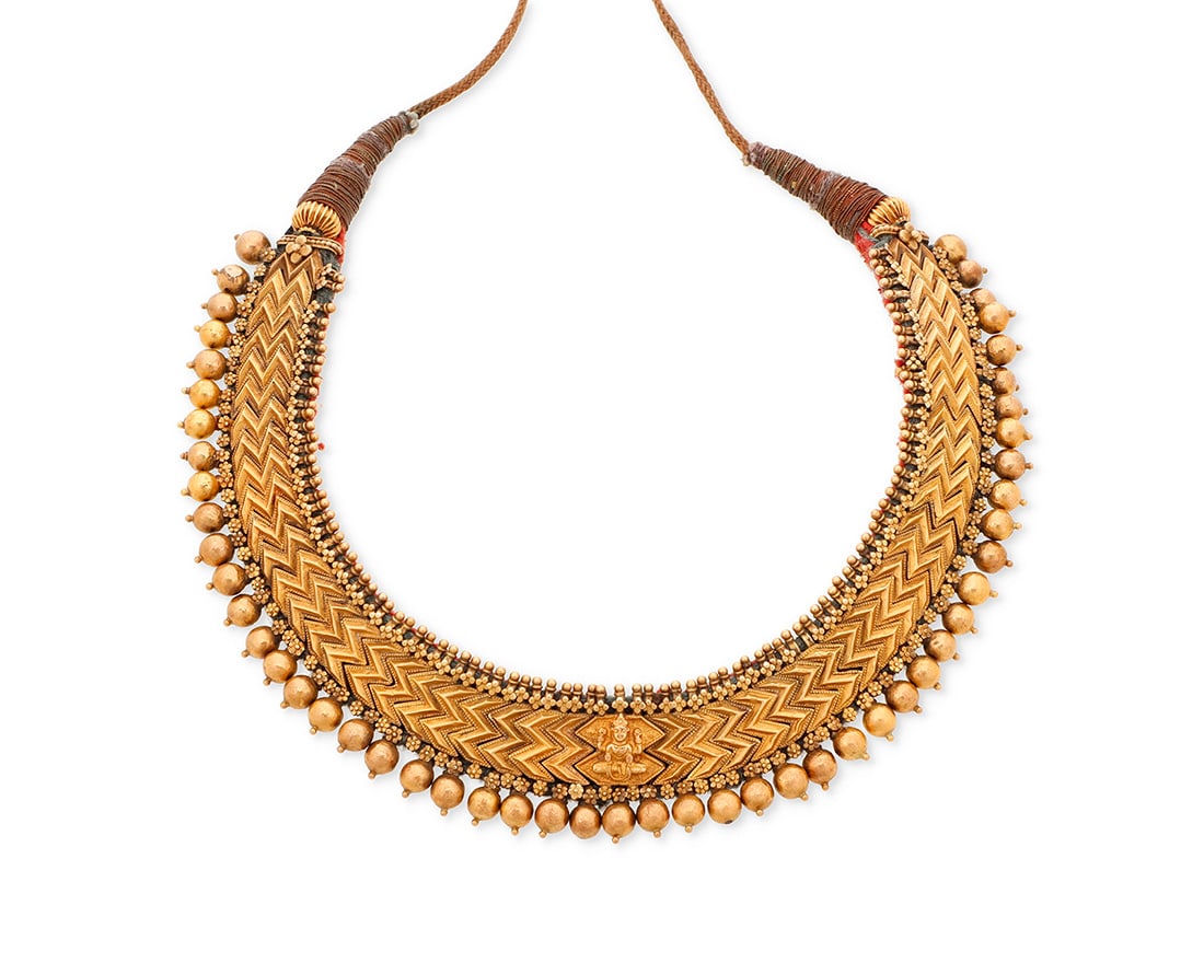 A 20K Gold Mughal Style Necklace: A 20K Gold Mughal Style Necklace Of a bib design featuring a chevron motif Length: 13 1/4 in. 81.4 grams