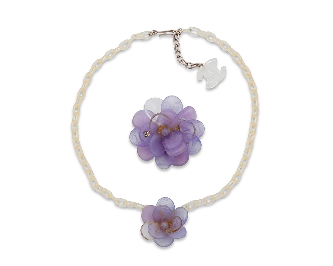 CHANEL: A Set of P‚te de Verre Camelia Jewelry, 2001: CHANEL: A Set of P‚te de Verre Camelia Jewelry, 2001 A demi-parure featuring lavender purple glass camellias, comprising a choker necklace with a clear acrylic chain and CC charm to hook clasp,
