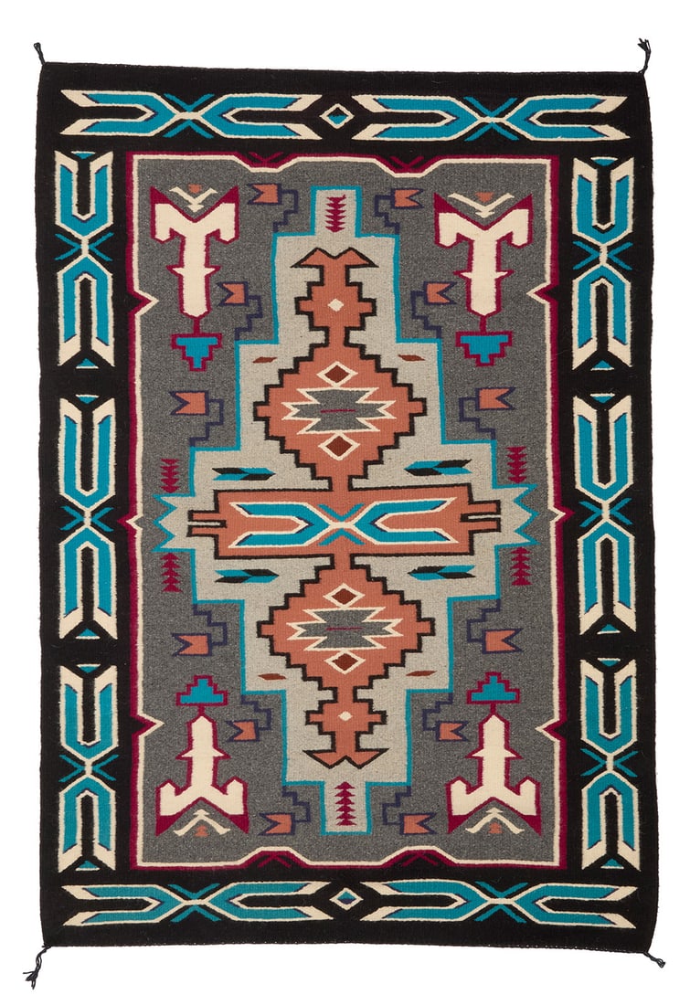 A Navajo Teec Nos Pos rug Late 20th century, Dine, Daisy King Woven in grey, black, blue, maroon,: A Navajo Teec Nos Pos rug Late 20th century, Dine, Daisy King Woven in grey, black, blue, maroon, salmon, and cream wool, depicting an elongated stepped diamond with central X-form motif and