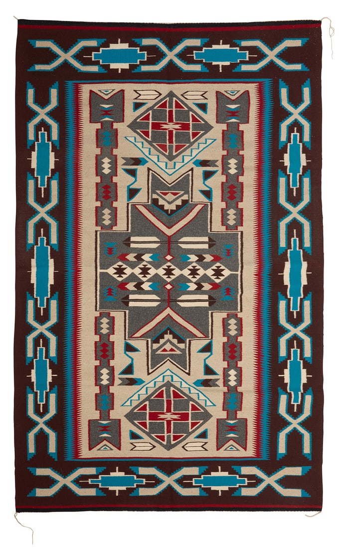 A Navajo Teec Nos Pos rug Late 20th century, Dine, Rose Nargo Woven in brown, black, red,: A Navajo Teec Nos Pos rug Late 20th century, Dine, Rose Nargo Woven in brown, black, red, turquoise, natural grey, and cream wool, with feather motifs and stacked diamonds within a stepped x-form